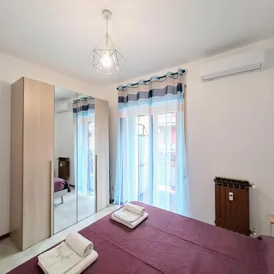 a bedroom with a large bed with a mirror at Cozy apartment near metro A in Rome
