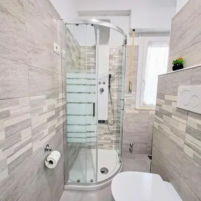 a bathroom with a shower and a toilet at Cozy apartment near metro A in Rome