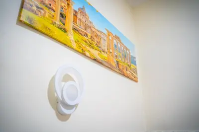 a bathroom with a picture of a train on the wall at Affittacamere Tiche in Rome
