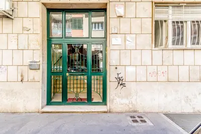 a green door on the side of a building at True Colors Vatican Home in Rome