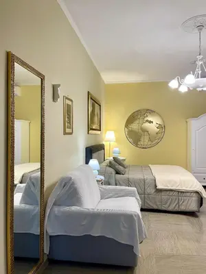 a bedroom with two beds and a mirror at Barbi's Home- Colli Albani Roma in Rome
