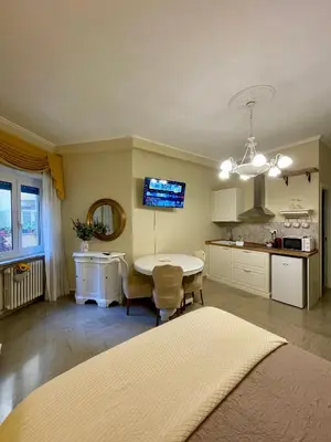 a kitchen with a table and a dining room at Barbi's Home- Colli Albani Roma in Rome