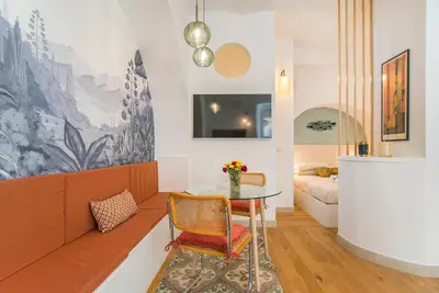 a living room with a table and a couch at 15 minutes to Colosseum - Loft with terrace in Rome