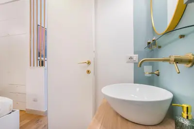 a bathroom with a white bowl sink and a mirror at 15 minutes to Colosseum - Loft with terrace in Rome