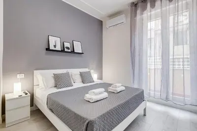 a white bedroom with a bed with towels on it at Dimora Testaccio in Rome