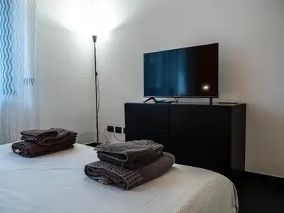 a bedroom with a tv on a bed with towels at Conca D'oro Colors - Metro & WI-FI in Rome