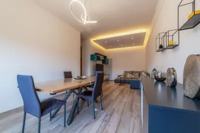 a kitchen and dining room with a wooden table and chairs at Giorgia Flat - Tiburtina Train Station - Wi-Fi in Rome