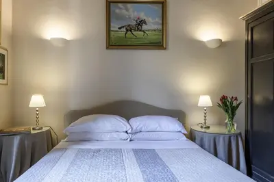 a bedroom with a bed with a horse painting on the wall at Piazza della Maddalena view in Rome