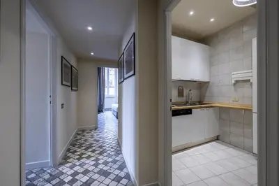 a kitchen with white cabinets and a tile floor at Piazza della Maddalena view in Rome