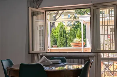 a dining room with a table and a large window at Vatican Luisa in Rome