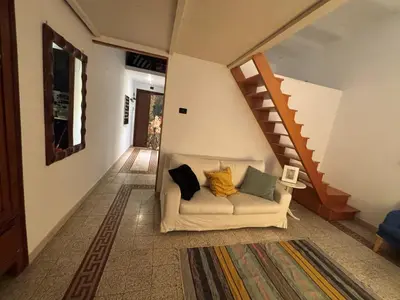 a living room with a couch and a staircase at Valentina Suite Colosseo in Rome