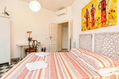 a hallway with a red couch in a white room at Vatica B&B Roma in Rome