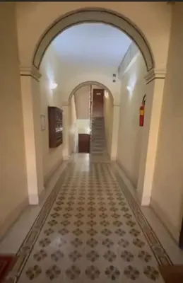 an empty hallway with a tile floor and an archway at Granma Apt in Rome