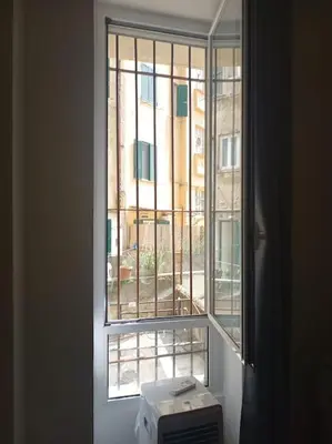a window with a view of a building at Monolocale vicino metro Libia in Rome