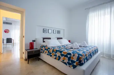 a bedroom with a bed with a blue and white blanket at Elegante Appartamento Vaticano Lattanzio in Rome
