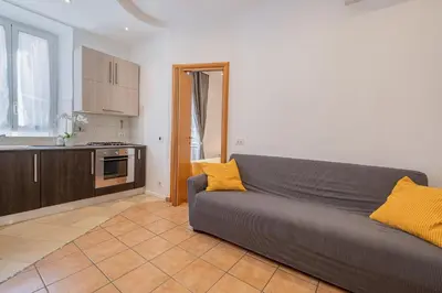 a living room with a couch and a kitchen at Happy Home in Rome