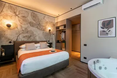 a bedroom with a large bed and a bath tub at San Giovanni Luxury Rooms in Rome