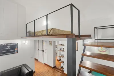 a duplex apartment with a staircase with a shoe rack at Pretorius Design Loft - Near Termini Station by RHR in Rome