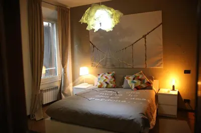 a bedroom with a bed with two lights on at Casa di Egeria al Colosseo in Rome