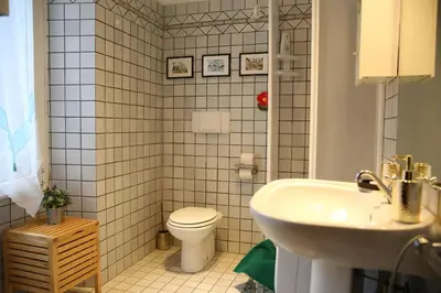 a bathroom with a white toilet and a sink at Casa di Egeria al Colosseo in Rome