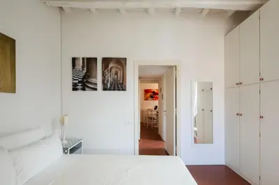 a bedroom with white walls and a white bed at Casa Mandes Spanish Steps in Rome