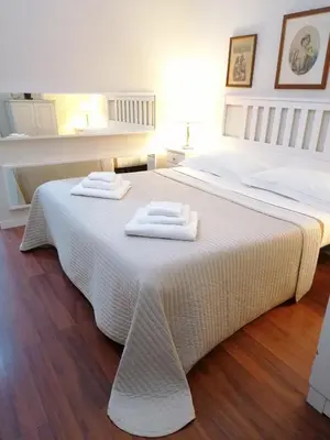 a white bed with two towels on top of it at Romebest in Rome
