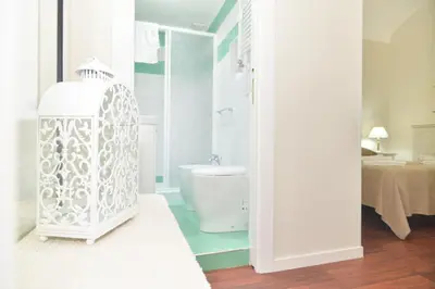 a white bathroom with a toilet and a sink at Romebest in Rome