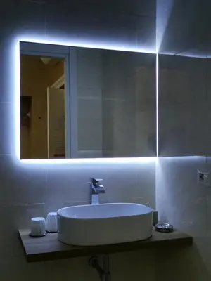 a bathroom with a white sink and a mirror at B&B Roma Royal Residence in Rome