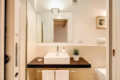 a bathroom with a sink and a mirror at YH Suite in Rome