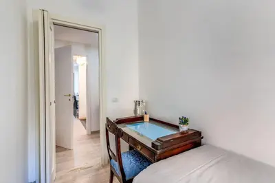 a bedroom with a bed and a glass table at Maison St Camillo Rome Centre in Rome