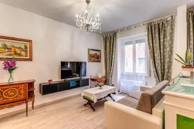 a living room with a couch and a television at Maison St Camillo Rome Centre in Rome