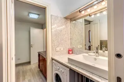 a bathroom with a sink and a mirror at Maison St Camillo Rome Centre in Rome