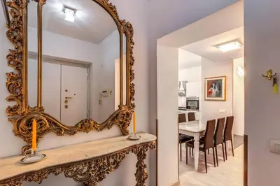 an ornate mirror on a table in a dining room at Maison St Camillo Rome Centre in Rome