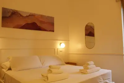 a bedroom with a bed with towels on it at Don Raffaele Resort Roma - Guest House in Trastevere