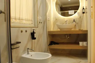 a bathroom with a sink and a mirror at Don Raffaele Resort Roma - Guest House in Trastevere