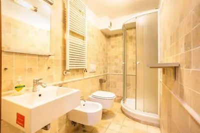 a bathroom with a sink and a toilet at Il Nido -Cinema HD & Relax Space in Rome