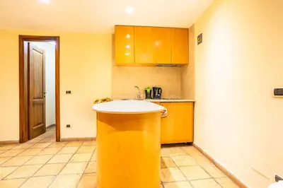 a kitchen with a yellow sink in a room at Il Nido -Cinema HD & Relax Space in Rome