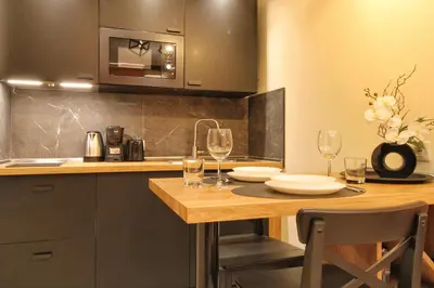 a kitchen with a wooden table with glasses of wine at Domus Grottae at Campo de fiori in Rome