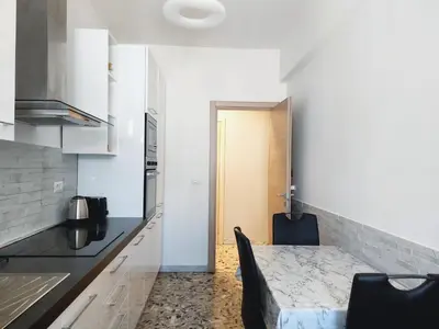 a kitchen with a table and a counter top at Luminoso a due passi da Trastevere in Rome