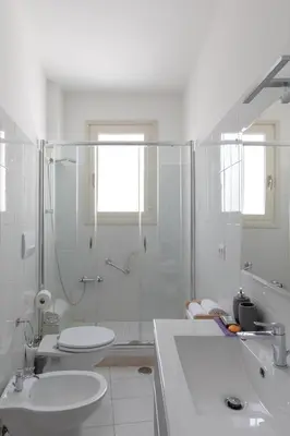 a bathroom with a shower and a toilet and a sink at Luminoso a due passi da Trastevere in Rome