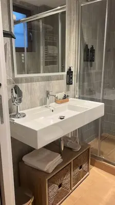 a bathroom with a white sink and a mirror at Domus Romano Campo de Fiori in Rome