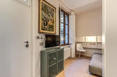 a living room with a flat screen tv on a wall at Domus Romano Campo de Fiori in Rome