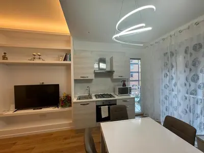 a kitchen with a television and a table with chairs at Roman Pearl in Portuense in Rome