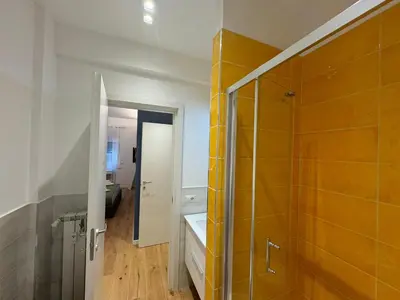 a bathroom with a walk in shower and a sink at Roman Pearl in Portuense in Rome