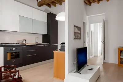a kitchen with a tv on a table in a room at NEW! Design apartment 2 min from Spanish Steps in Rome