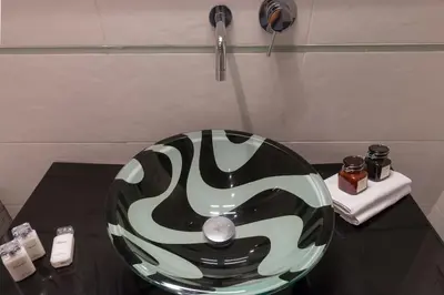a black and white bowl on a table in a bathroom at NEW! Design apartment 2 min from Spanish Steps in Rome