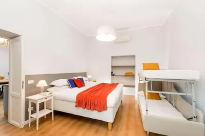 a bedroom with two bunk beds and a desk at Big Flat in the Heart of Trastevere 4 bedrooms 3 bath in Rome