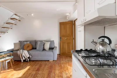 a kitchen and living room with a couch and a stove at Manara flats in the Heart of Trastevere in Rome
