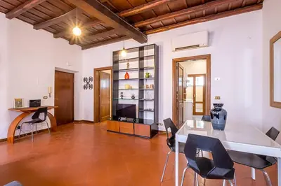 a living room with a table and chairs at ht vicolo 6 bilo in Rome