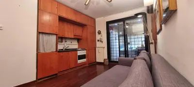 a living room with a couch and a kitchen at Er Core Nostro in Rome